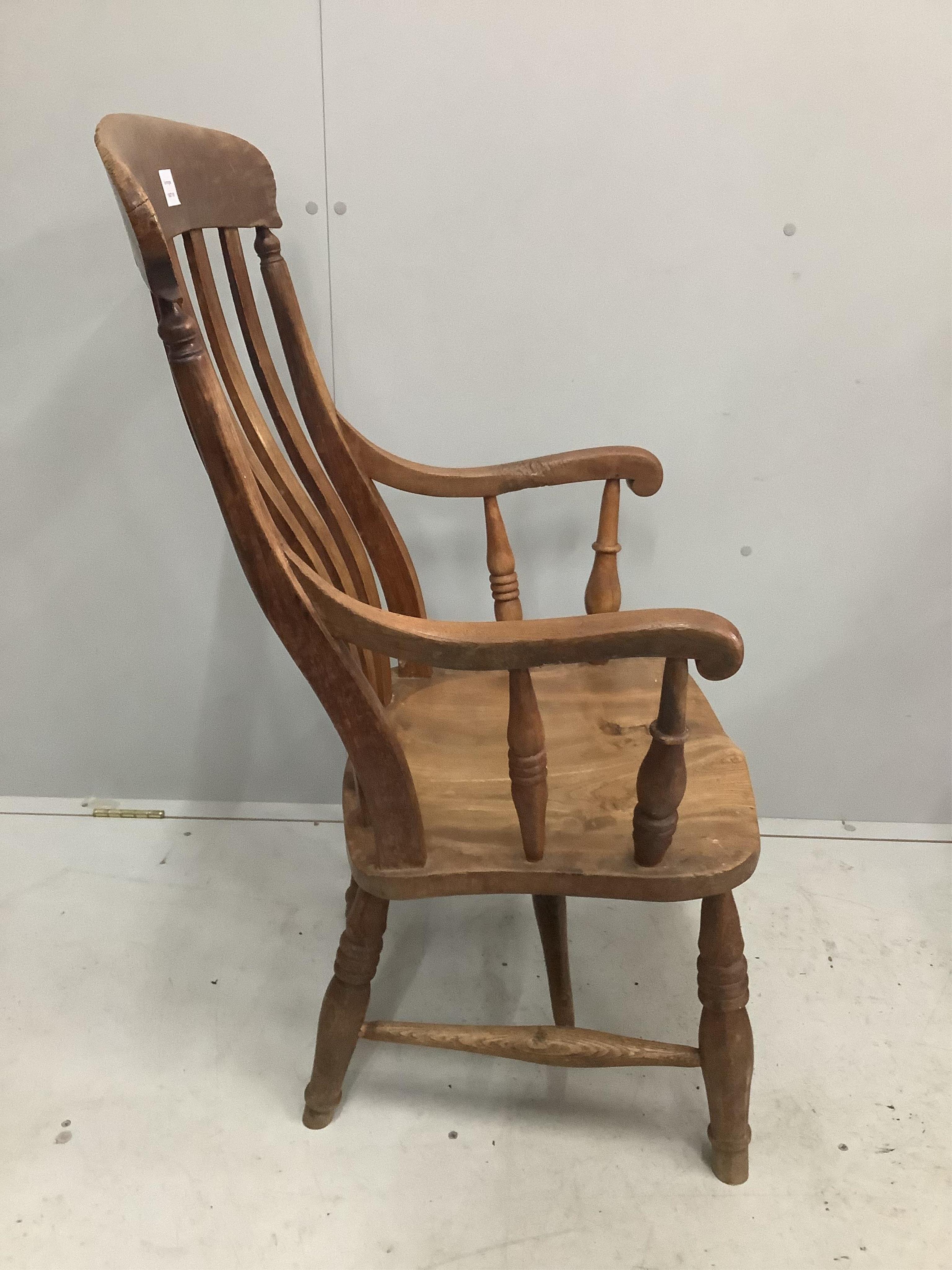 A Victorian elm and beech Windsor lathe back elbow chair, width 53cm, depth 44cm, height 104cm. Condition - fair